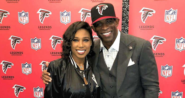 Deiondra Sanders poses with her father, Deion, at Falcons Legends event